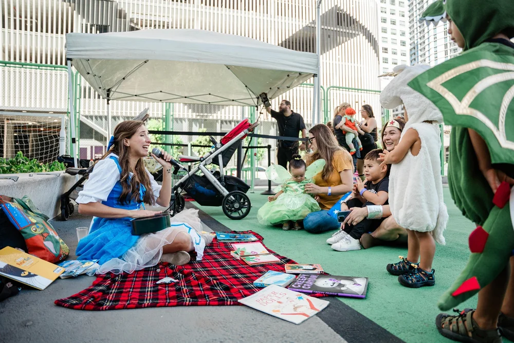 Children and caregivers enjoying an outdoor storytelling activity